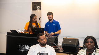 High school students and Seton Hall faculty convened at Seton Hall's Be the Change conference. Image of adults and teens taking a picture with a frame that says #BeTheChangeMakers.Image of CCRE Director Timothy Hoffman and high school students during Seton Hall's Be the Change conference