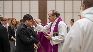 Father John distributing ashes
