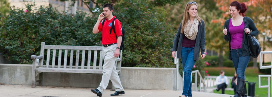 Students walking and talking on campus.