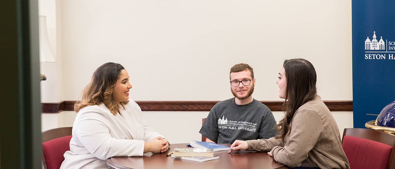 Diplomacy Undergraduate Students Working at a Table