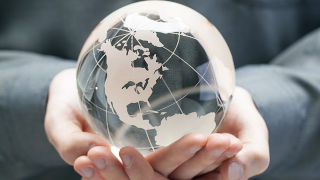 Person holding a glass globe