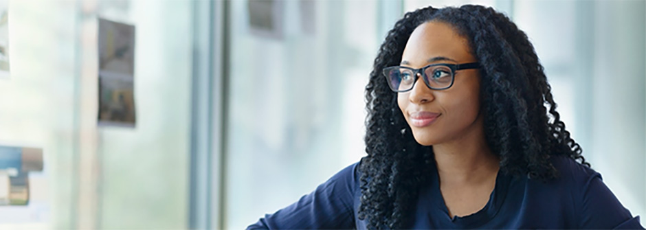 A woman in glasses looking off to the side.