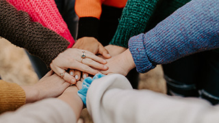 Image of multi-cultural hands joining together.