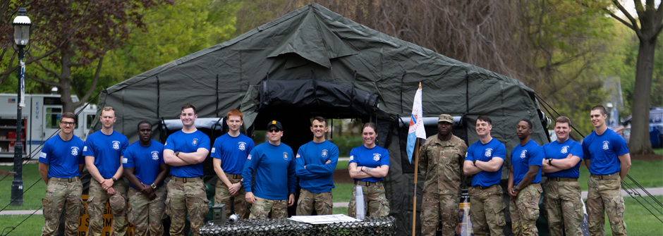 Image of ROTC members during Pirate Week 2023 in front of a tent. 