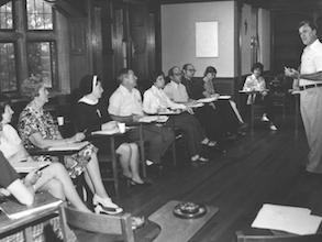 1970s. Reverend Leo Humanae conducting class for lay students and sisters. - Farley 1970s. Reverend Leo Humanae conducting class for lay students and sisters. - Farley