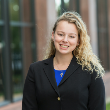 Image of student Mary Grace McNamara wearing a blazer on campus. 