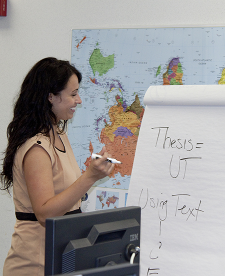 A teacher writing on a large notepad