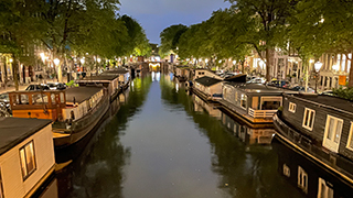 Amsterdam canal lit up at night