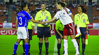 Andrea Neil with her team at the start of a soccer match.