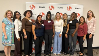 Mary Landriau with Seton Hall’s nine senior social worker students.