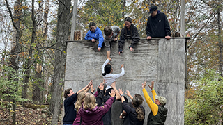 Leadership students take on the 15-foot wall climb.