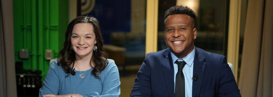 A photo of two SHU Communication students at a news desk