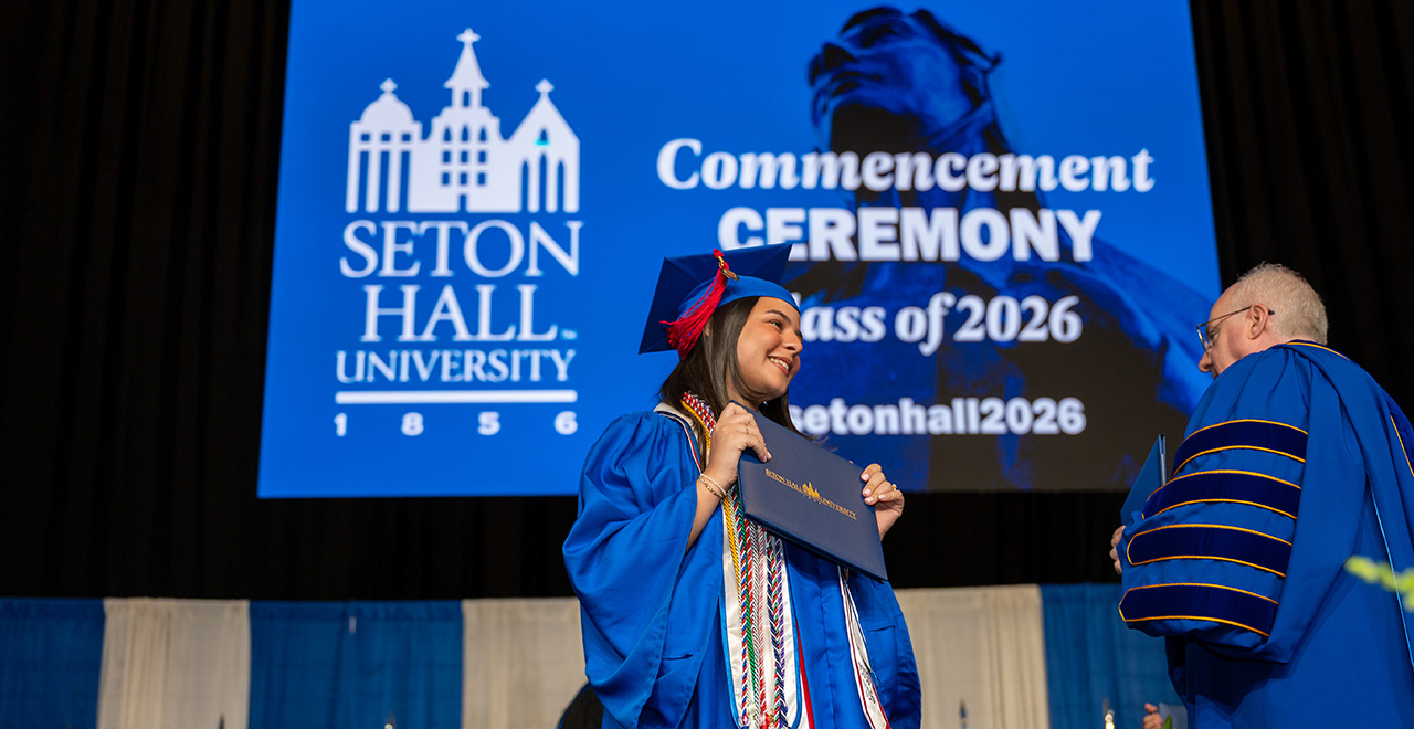 A photo of a student getting their diploma at graduation.