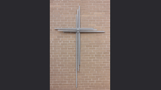 A photo of a cross on a wall