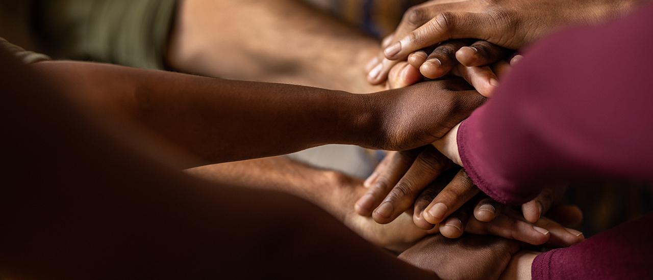 A photo of a group of people holding hands