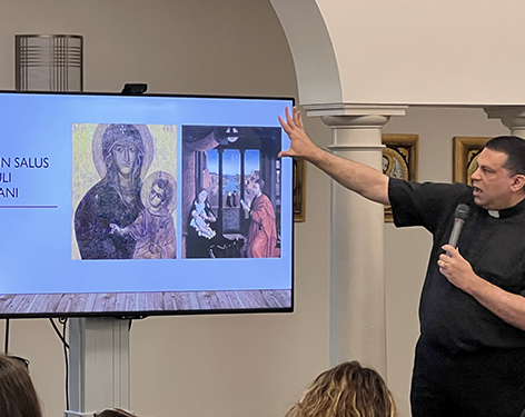 Father Ciriaco describing a painting.