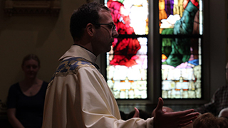 Father Nick Sertich preaching Mass