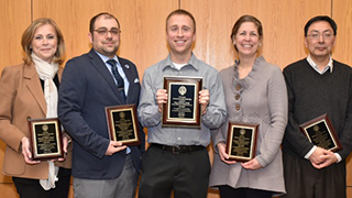 Four faculty members who won Researcher of the Year with their awards. 