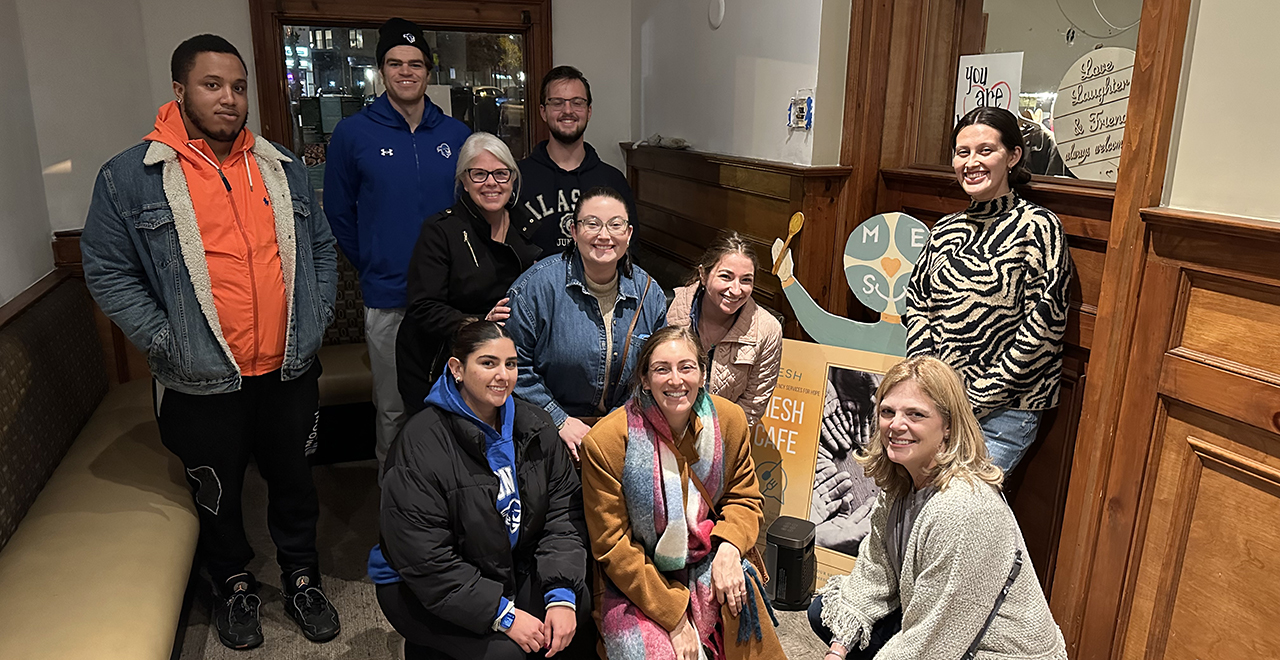 Gabrielle Rossi, Ph.D., and her MPA Students posing for a picture while volunteering at MESH