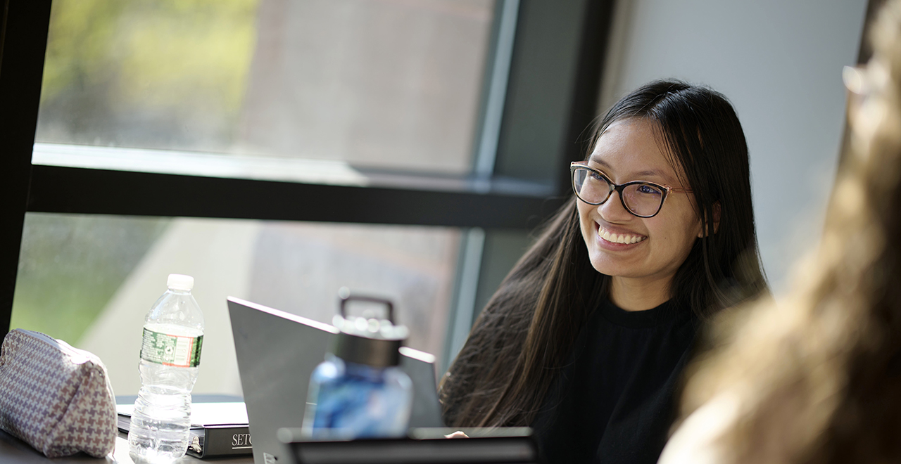 Graduate student near window Graduate student near window
