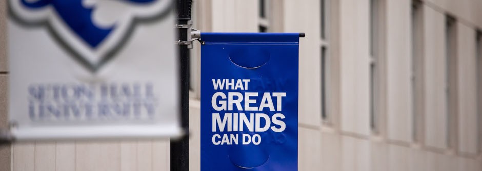 What Great Minds Can Do banner outside of the Walsh Library. 