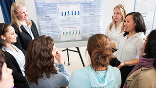 Students at a poster presentation.