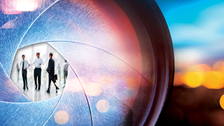Looking at business professionals through a scope.