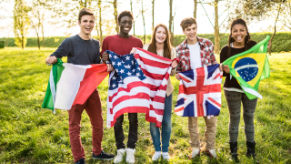 multinational students raising their flags.