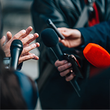 Journalists interviewing someone with a recorder