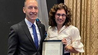 A photo of Karen Boroff accepting an award. 