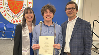 Lauren McFadden and Daniel Moore with a student