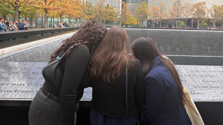 Students overlooking the 9/11 memorial pools