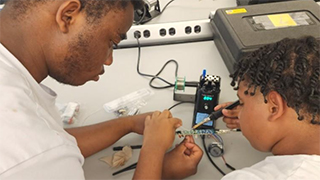 Students working on circuit board
