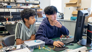 LEAP students using a computer for robotics