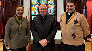 Monsignor Harahan (center) with Angelica Bullock (left) and Father Dominic Ciriaco (right)