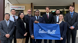 NSF Fellows in Tokyo holding Seton Hall flag