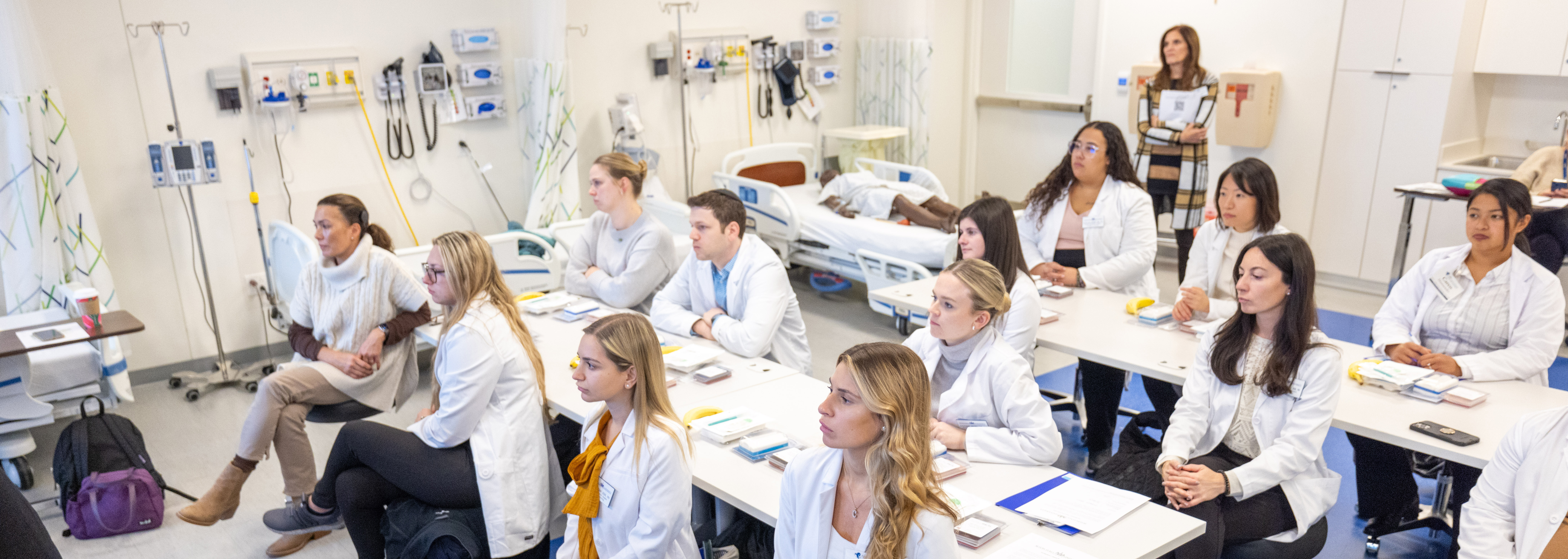 Nursing students paying attention in a classroom.