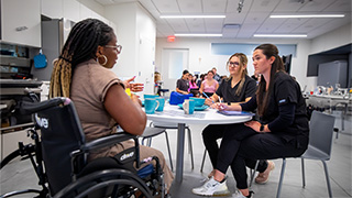 M.S.O.T students interacting with patient