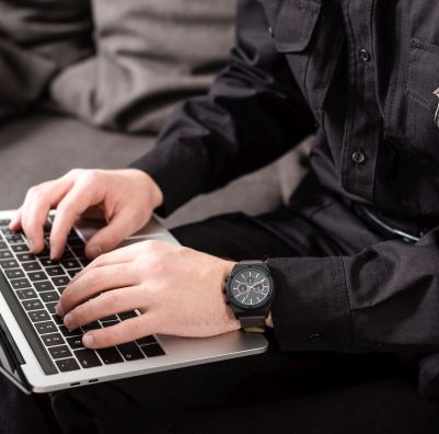 A photo of an officer on their laptop