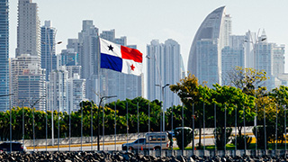 Panama flag with the city in the background.