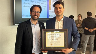 Dean Jonathan Farina pictured with Marius Pelmus, accepting his award.