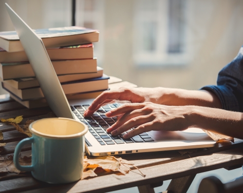 A person typing on their laptop