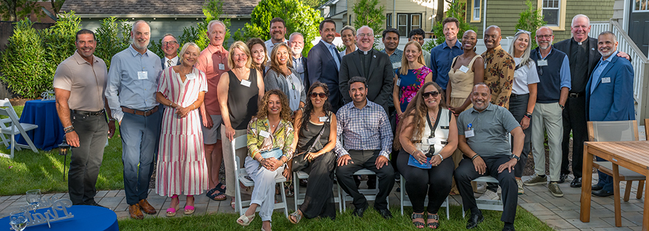 Parents, students and alumni pose with Seton Hall employees.
