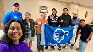 Group Selfie of Release the Doves with Seton Hall Banner