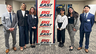 Students posing with the 'Big East' banner