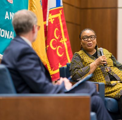 A photo of two people speaking at a conference