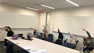 students doing yoga in a classroom