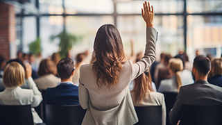 Attendee raising hand at a conference