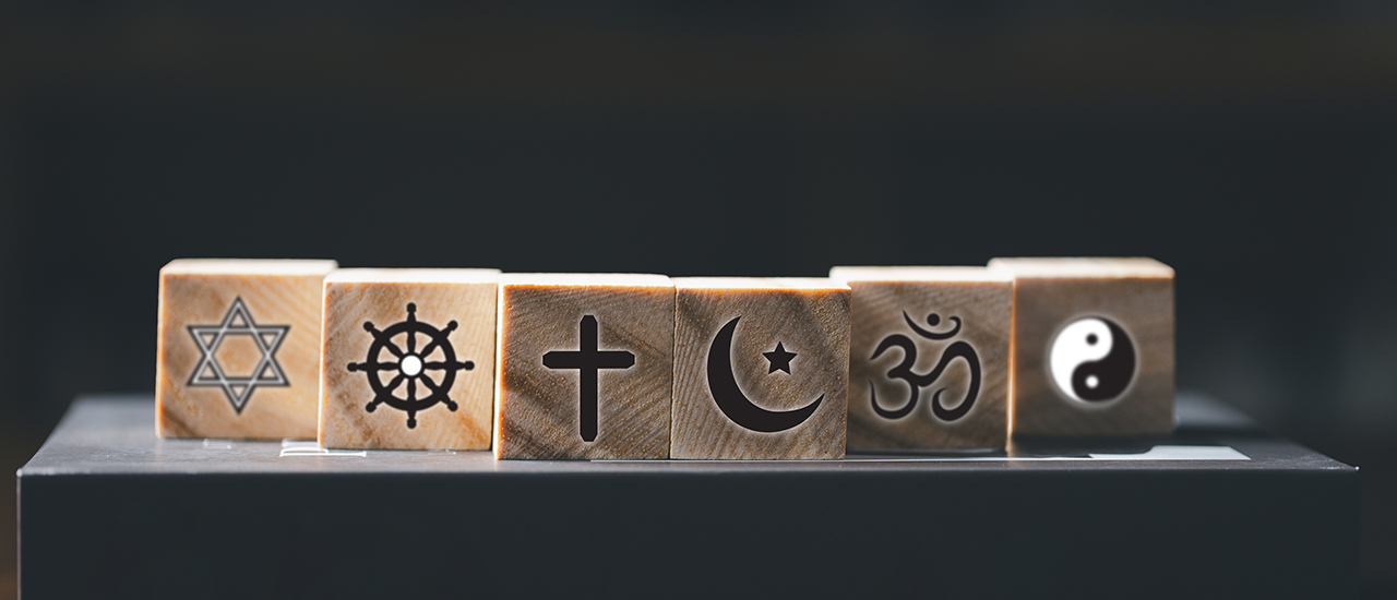 World Religions Symbols A row of wooden blocks, each with a symbol from a different world religion.